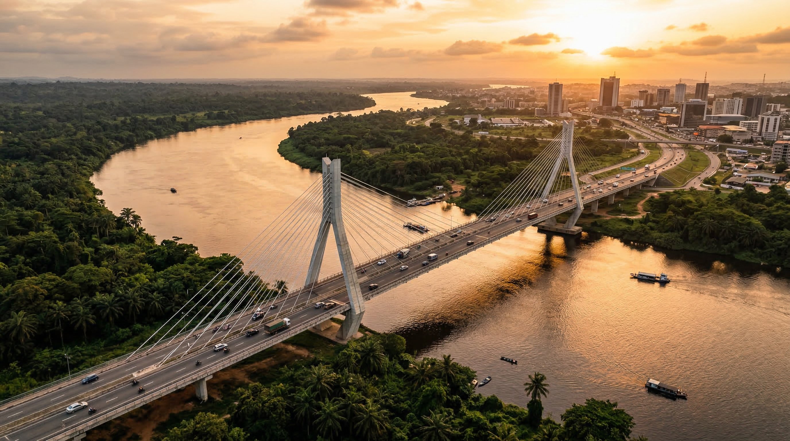 夕暮れ時にアフリカの河谷に架かる近代的な斜張橋 — フロンティアの風景の中心にあるインフラ